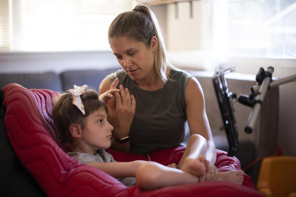 Jenny Eckart Hoyt directs her daughter Winnie's attention to an 