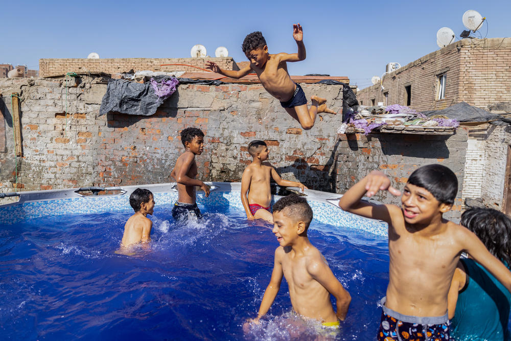 A wall acts as a makeshift diving board. The pool owner's 15-year-old son is the designated pool manager, making sure it doesn't get too crowded and telling the swimmers when their time is up.