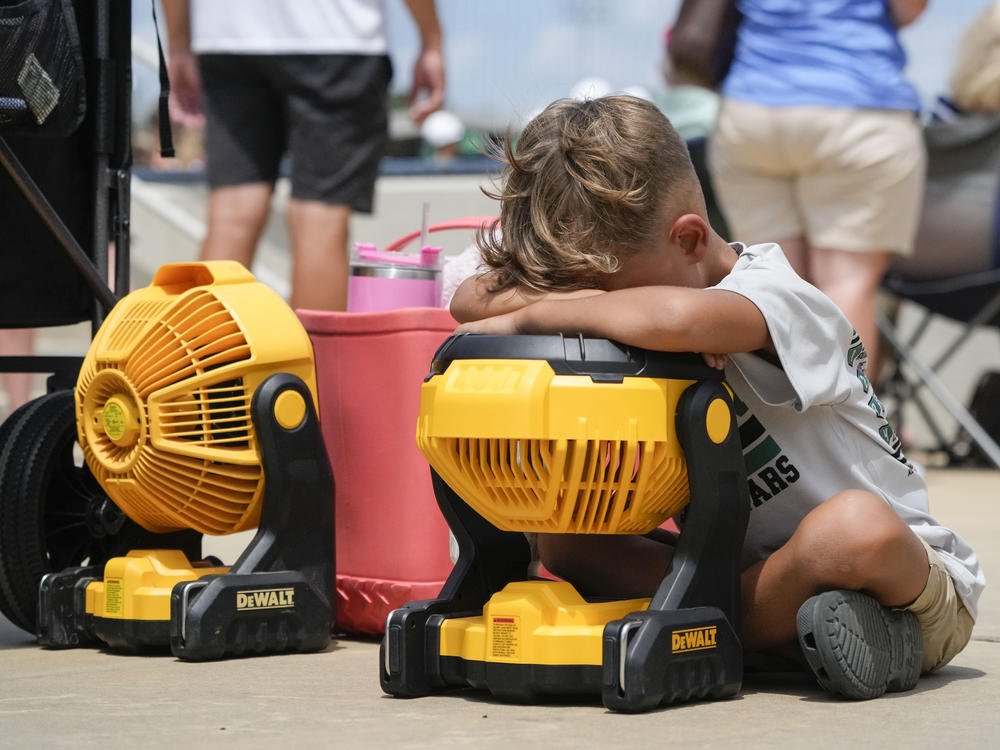 Braxton Hicks, 7, of Livingston, Texas, holds his face to a portable fan to cool off during a Little League tournament in Ruston, La., last week. More very hot weather is expected this weekend in much of the central U.S.