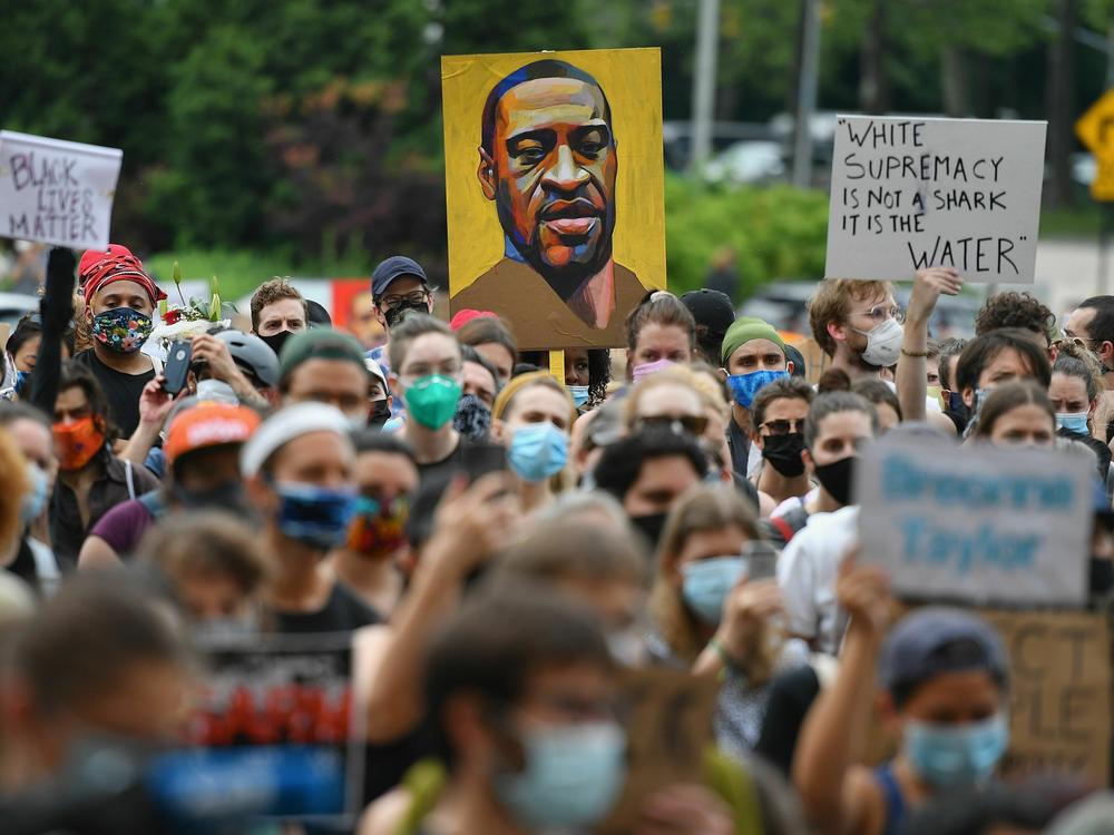 A protester holds up a portrait of George Floyd during a Black Lives Matter demonstration in Brooklyn, New York, on June 5, 2020. Following Floyd's murder, corporations rushed to respond to the moment, creating positions to address diversity, equity and inclusion in the workplace.