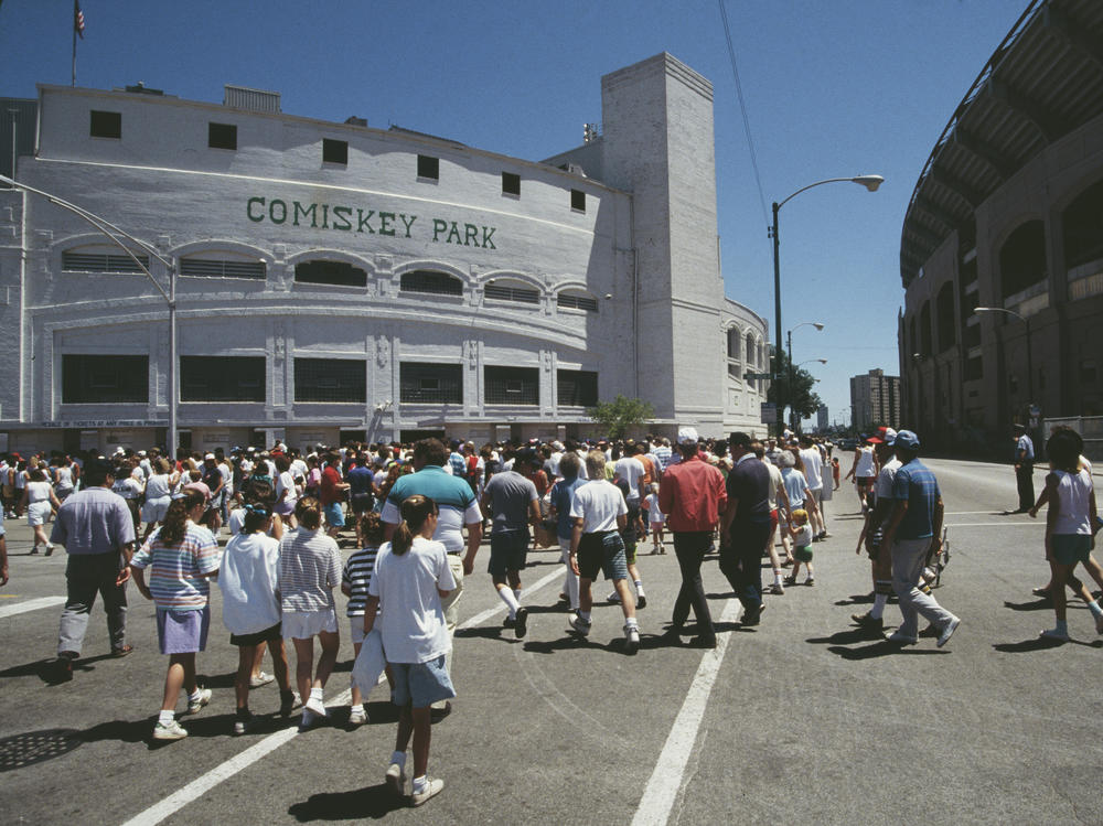 Fans and spectators walk to the entrance of Chicago's Comiskey Park on April 9, 1990, for the opening day of the final Major League Baseball season there.