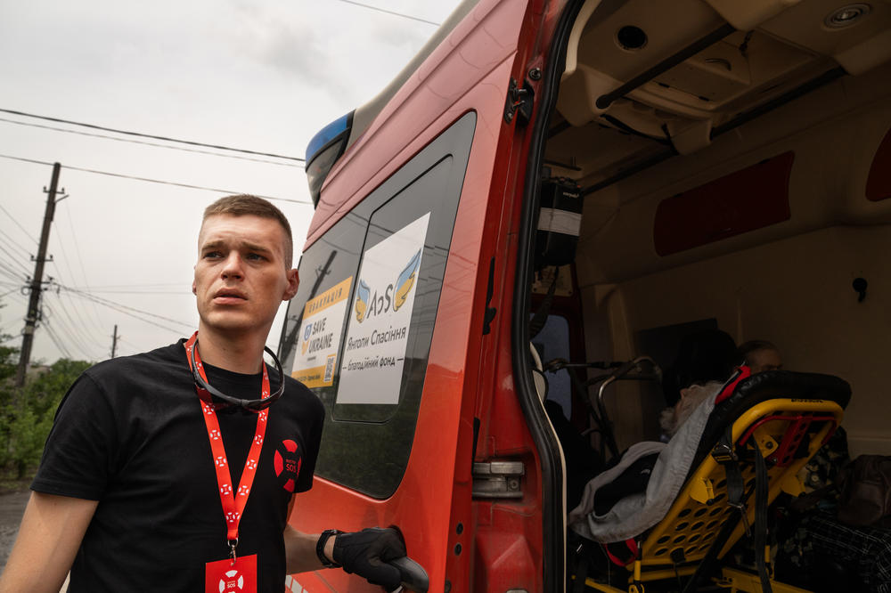 Skoryk helps to transfer evacuees into a van. He left his hometown of Bakhmut about a year ago, just as the fighting there was intensifying. Shortly afterward, he began working with an emergency response team.