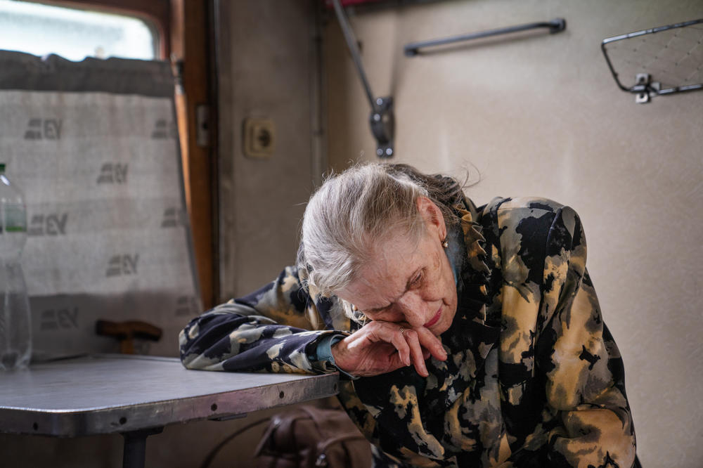 Lyudmilla Nesterova leans on a table on the evacuation train. She realized she will likely never see Toretsk again.