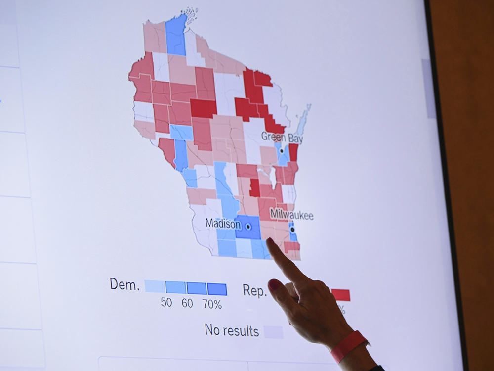 A supporter of Wisconsin Republican gubernatorial candidate Tim Michels points to incoming election data on Nov. 8, 2022, in Milwaukee. When Republican candidates for president gather for their first debate Wednesday in Milwaukee, the spotlight will not only be on them, but Wisconsin's role as one of a shrinking handful of genuine battleground states.