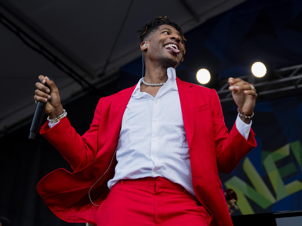 Jon Batiste performs at the Newport Folk festival on August 5, 2023. Batiste, a riveting live performer who has led the band at <em>The Late Show</em> and won an album of the year Grammy, just released a studio album, <em>World Music Radio</em>, that feels like an attempt to consolidate his billowing talent into a stable unit, like squeezing a genie back into the bottle.