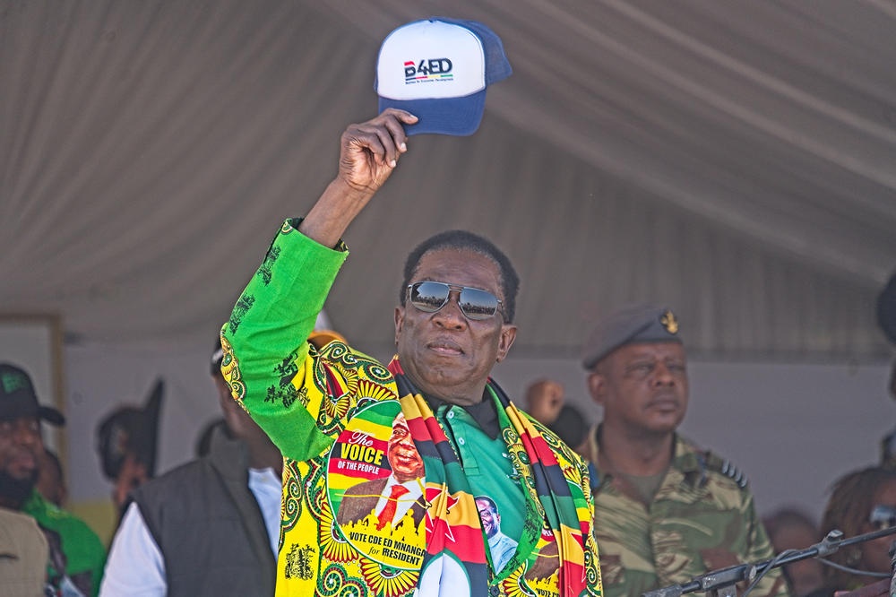 Zimbabwe's president, Emmerson Mnangagwa, lifts his hat to the crowd at his final reelection campaign rally on Saturday, ahead of general elections on Wednesday. Mnangagwa is confident of victory, but critics have said rising voter intimidation and bias of state institutions in favor of the ruling party risk the credibility of the election.