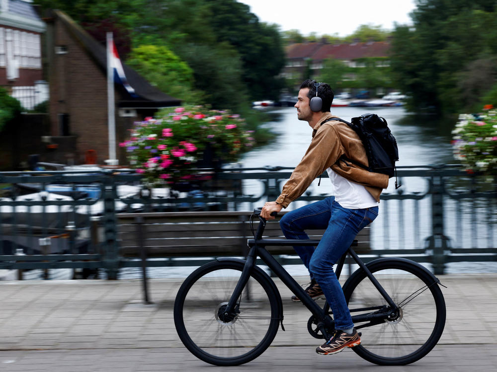 A man rides a VanMoof brand e-bike in Amsterdam, Netherlands, Aug. 17.