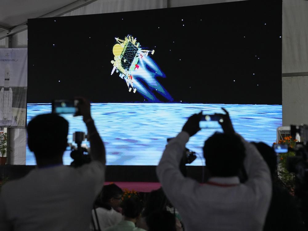 Journalists film the live telecast of spacecraft Chandrayaan-3 landing on the moon at ISRO's Telemetry, Tracking and Command Network facility in Bengaluru, India, on Wednesday, Aug. 23, 2023.