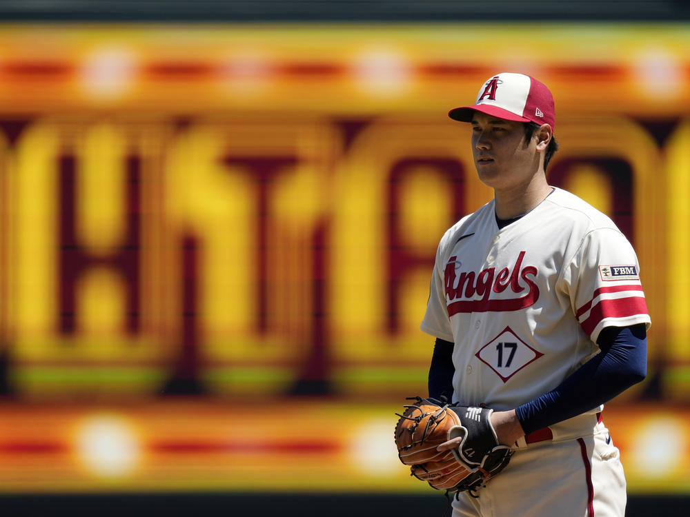 Los Angeles Angels starting pitcher Shohei Ohtani gets set to pitch during the first inning in the first baseball game of a doubleheader against the Cincinnati Reds on Wednesday, in Anaheim, Calif., before an MRI exam revealed his elbow tendon tear.