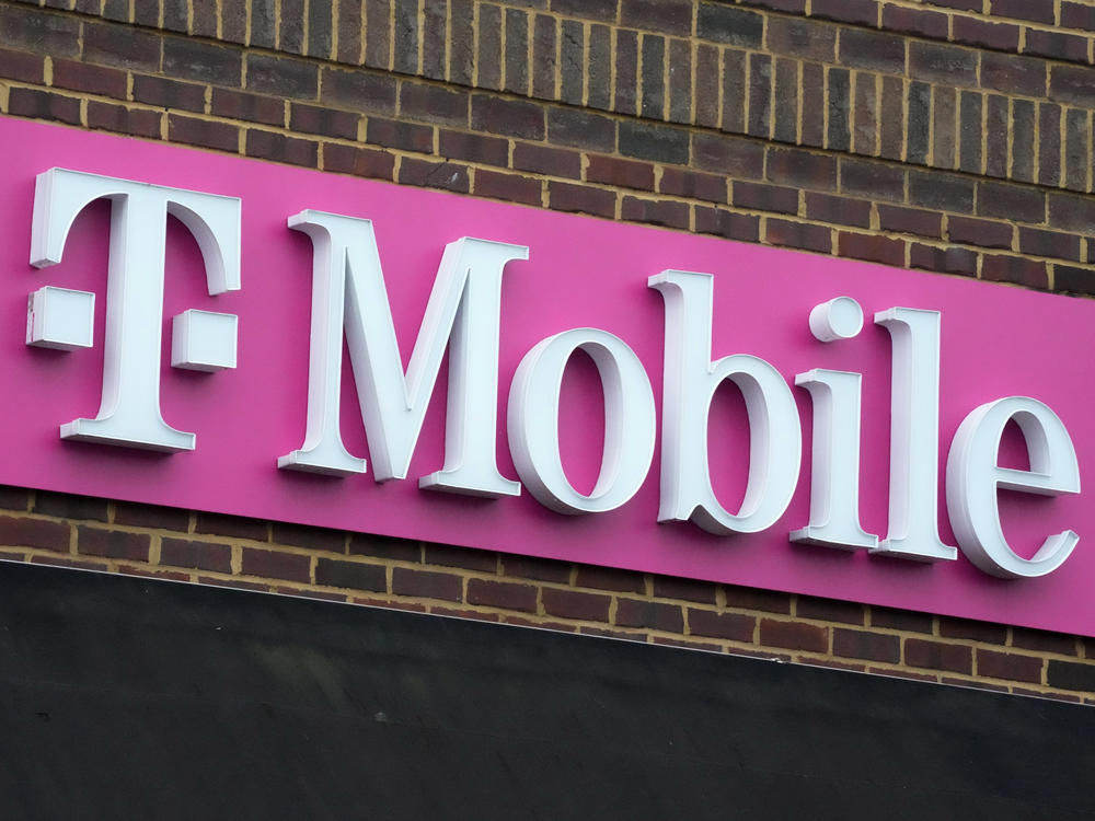The sign for a T-Mobile store is seen, Jan. 30, 2023, in Pittsburgh. T-Mobile plans to cut 5,000 jobs, or about 7% of its workforce, the U.S. wireless carrier announced Thursday, Aug. 24.