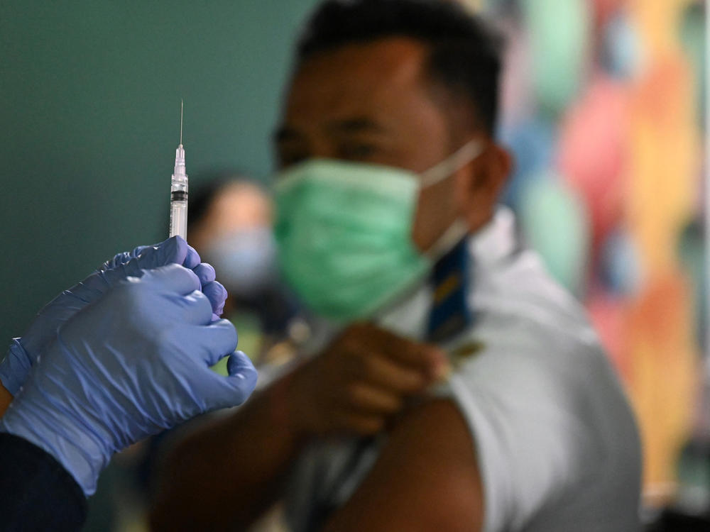 A booster vaccine is administered on the Indonesian resort island of Bali.