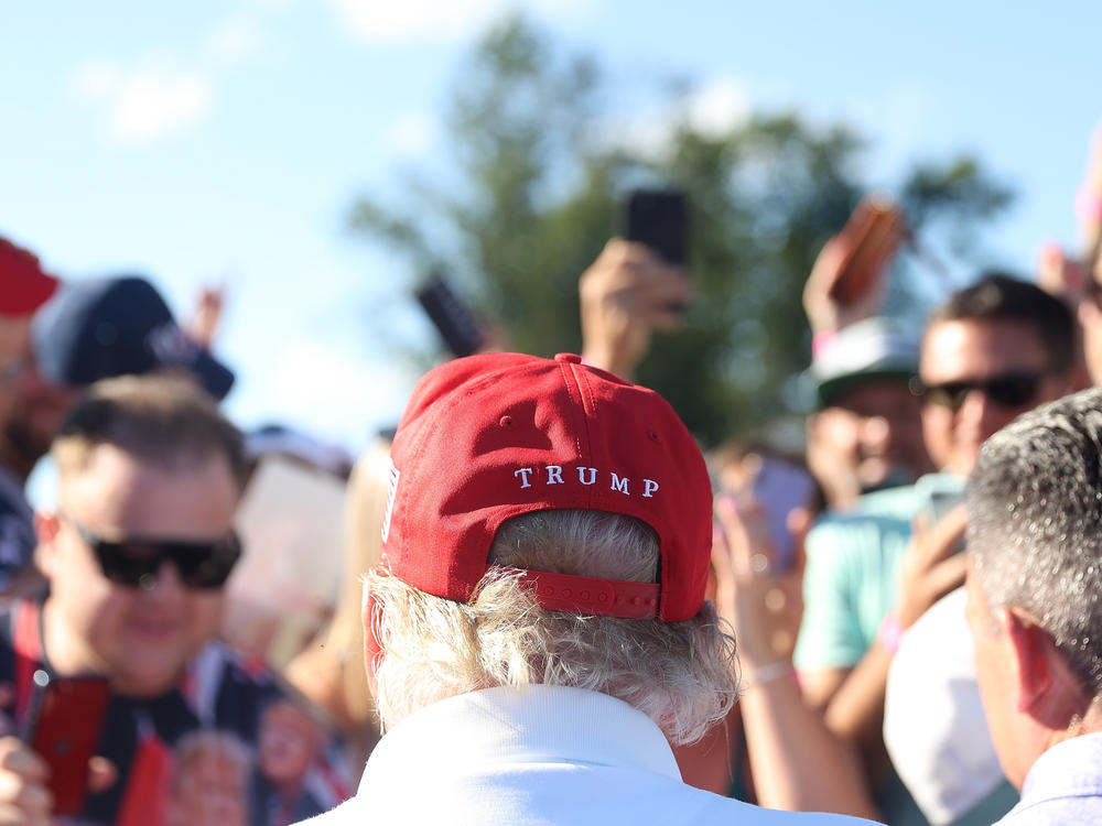 Former President Donald Trump signs autographs at Trump National Golf Club on Aug. 13 in Bedminster, N.J.