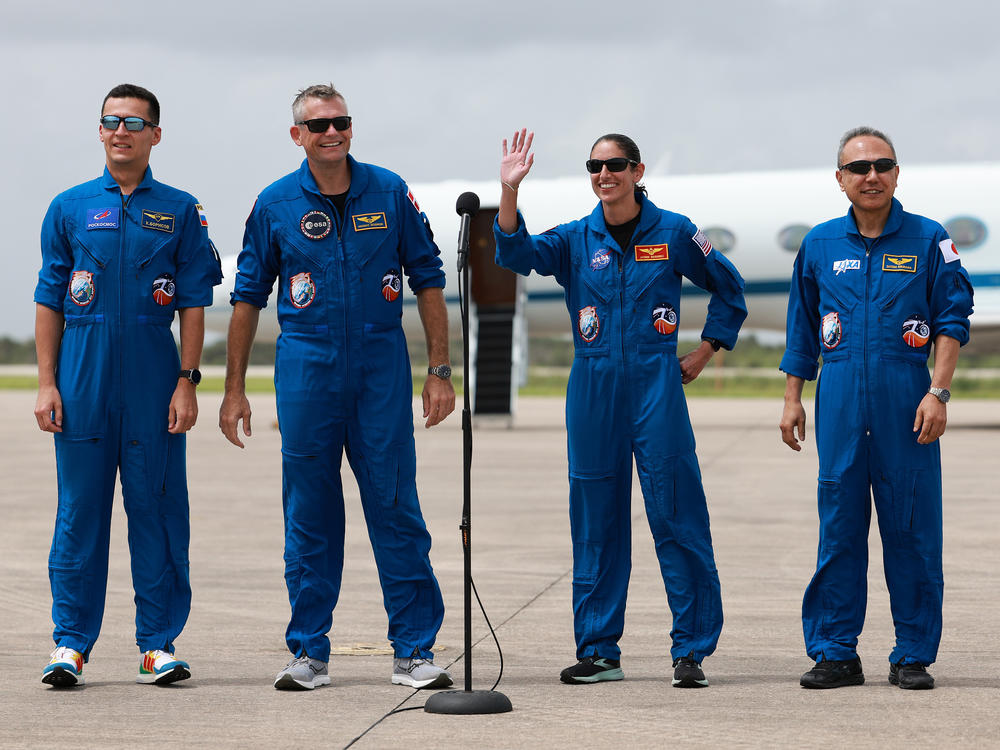 NASA and SpaceX Crew-7 members (L-R) Russian cosmonaut Konstantin Borisov, European Space Agency astronaut Andreas Mogensen, Mission commander and NASA astronaut Jasmin Moghbeli, and Japan Aerospace Exploration Agency astronaut Satoshi Furukawa, greet the media as they arrive at the Kennedy Space Center on August 20, 2023 in Cape Canaveral, Fla.