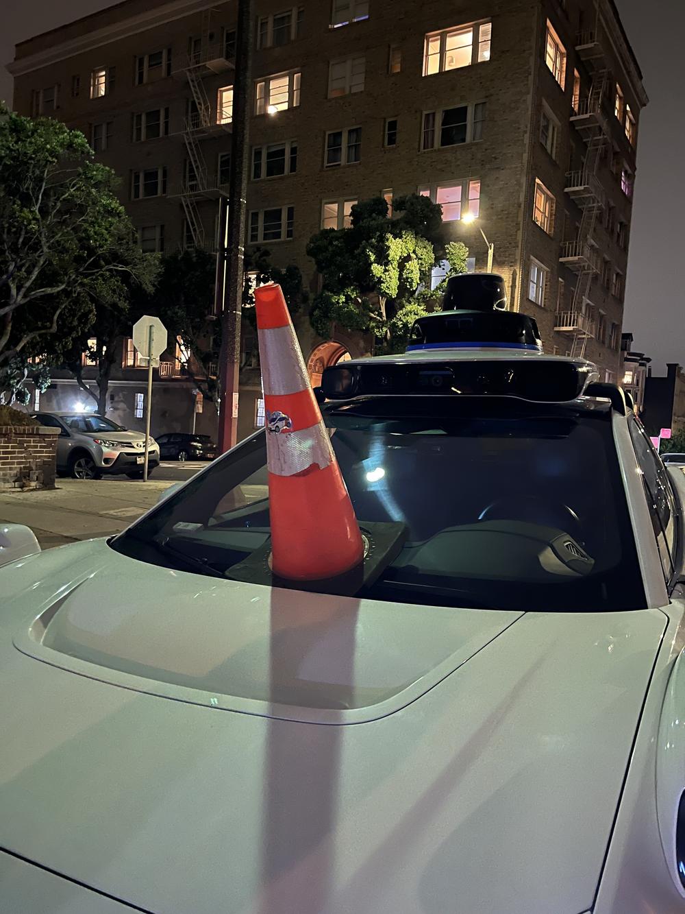 A Waymo driverless car gets coned in San Francisco.