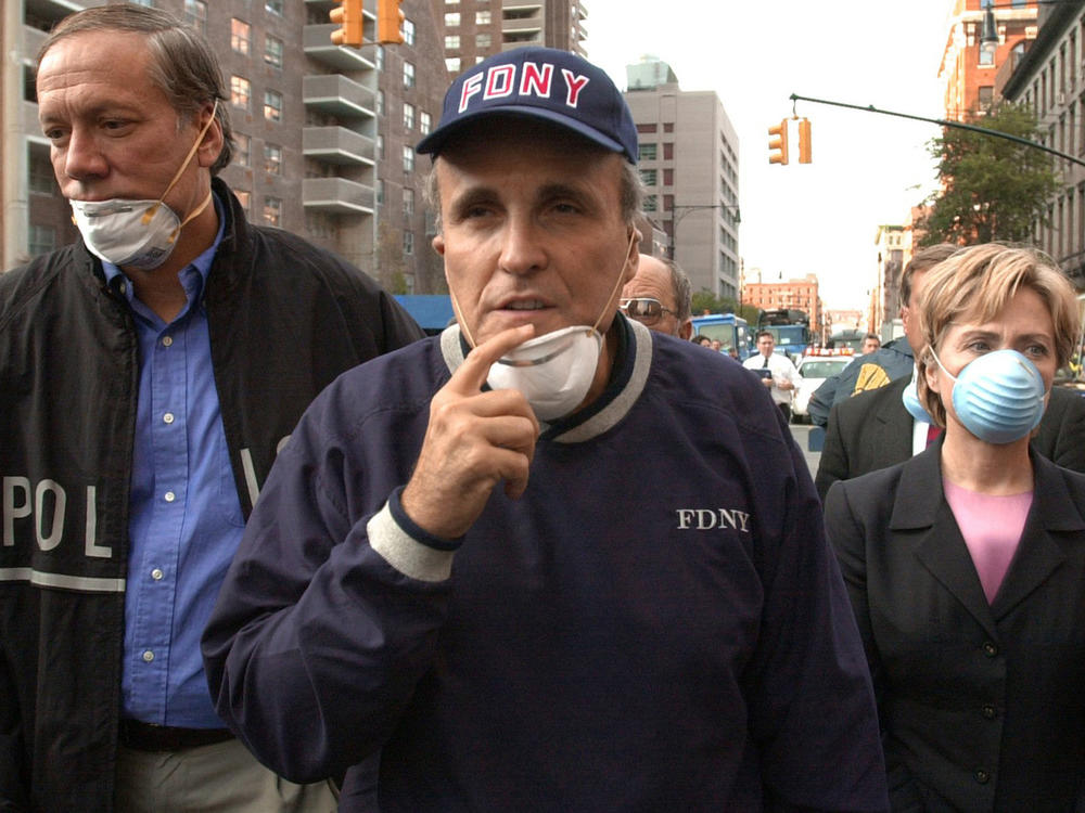 In this Sept. 12, 2001, file photo, now former New York City Mayor Rudolph Giuliani (center) leads then-New York Gov. George Pataki (left) and then-Sen. Hillary Clinton on a tour of the site of the World Trade Center disaster.