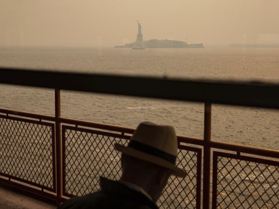 The Statue of Liberty is seen June 7 through a haze-filled sky from the Staten Island Ferry in New York. The smoke from Canadian wildfires that drifted into the U.S. led to a spike in people with asthma visiting emergency rooms — particularly in the New York area.