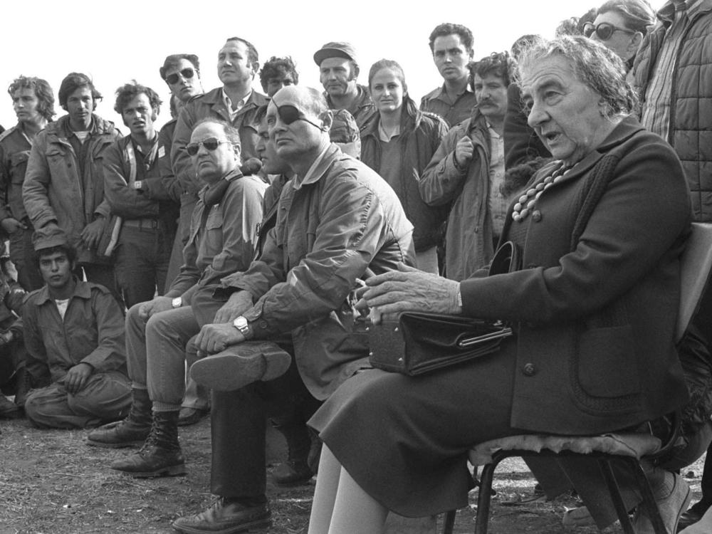Israeli Prime Minister Golda Meir and Defense Minister Moshe Dayan meet their troops on October 21, 1973 on the Golan Heights during the Yom Kippur War.