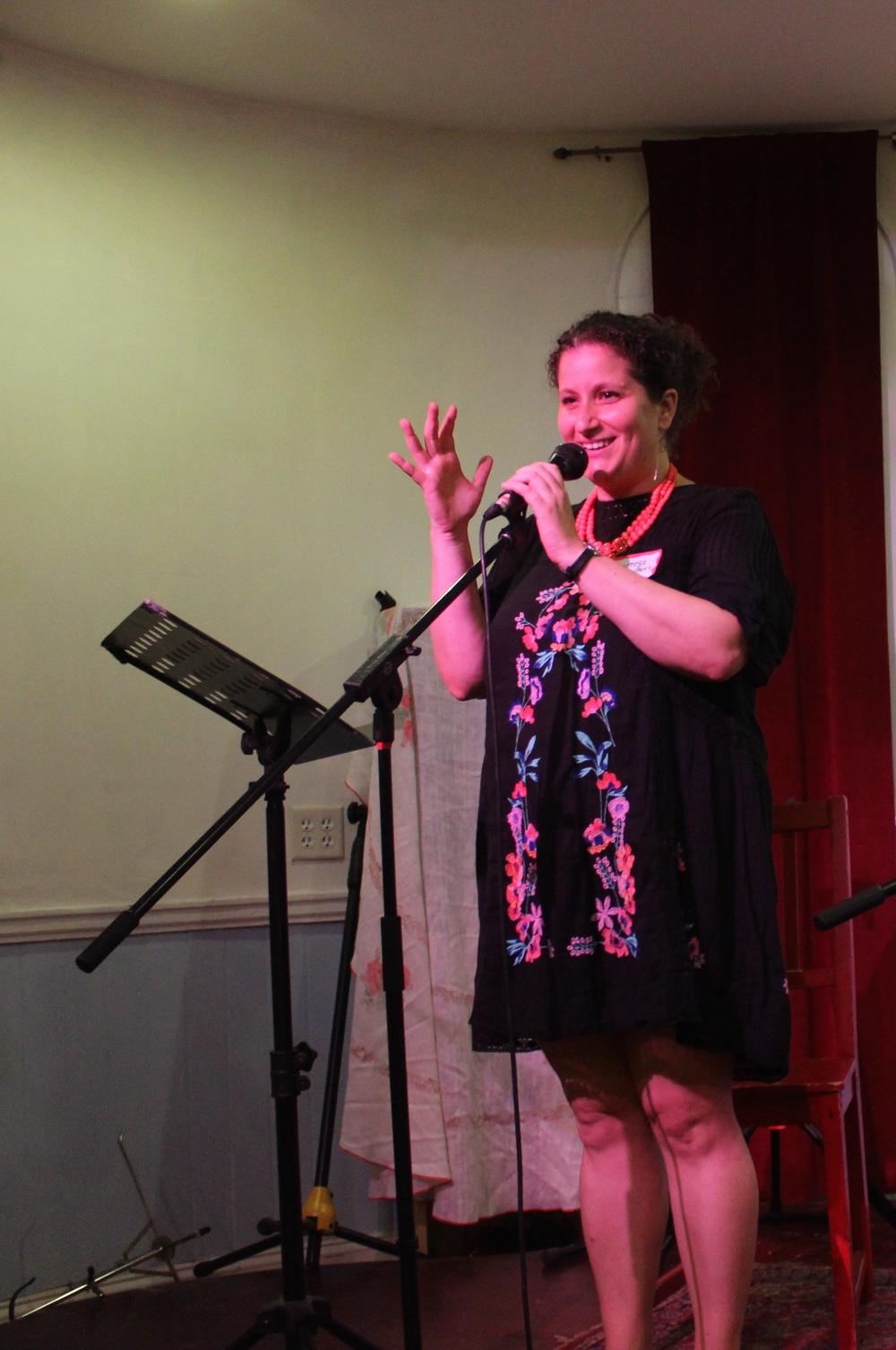 Vanessa Zoltan welcomes an audience for an event about treating romance novels as sacred text.