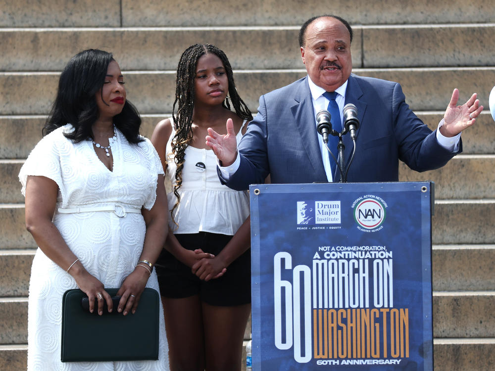 Civil rights activist Martin Luther King III, joined by his daughter Yolanda King (center) and wife Arndrea Waters King, delivers remarks at Saturday's rally in Washington, D.C.