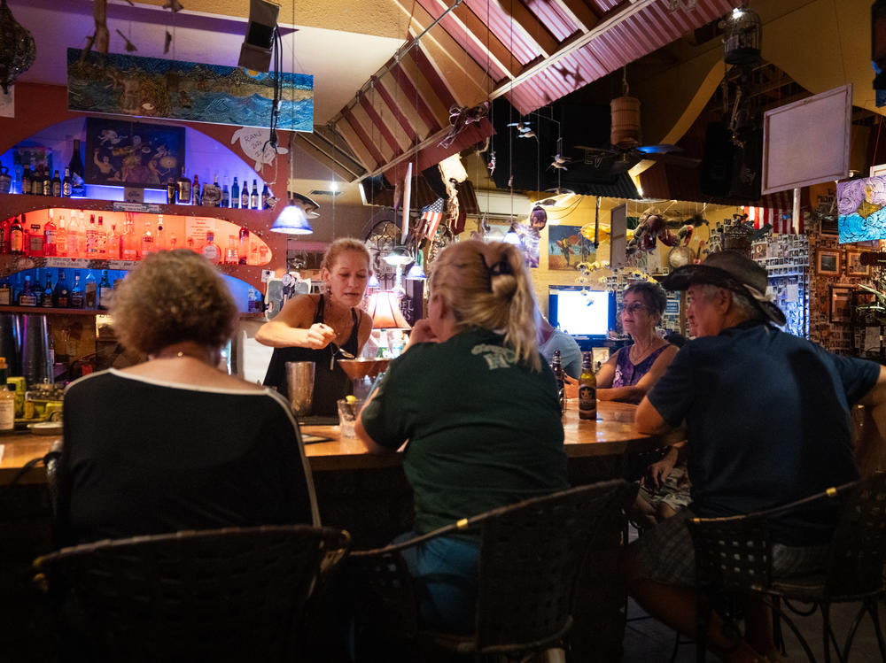 Cori Gross, bartender at Java Jazz, greets residents with bursts of joy to see that they've survived the fires.