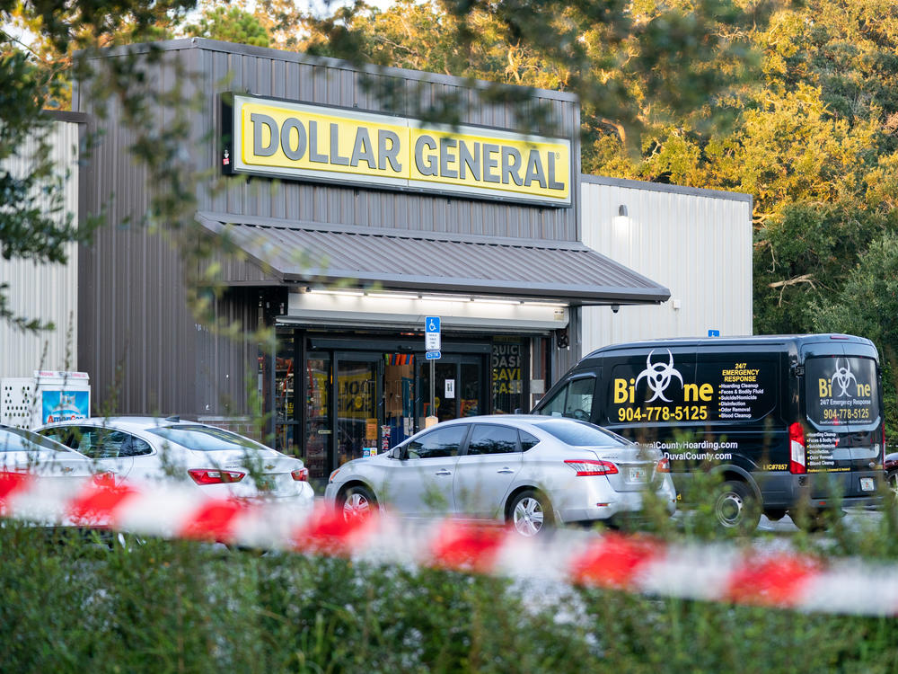 A biohazard cleanup vehicle is parked outside the Dollar General store where three people were shot and killed the day before on Aug. 27.