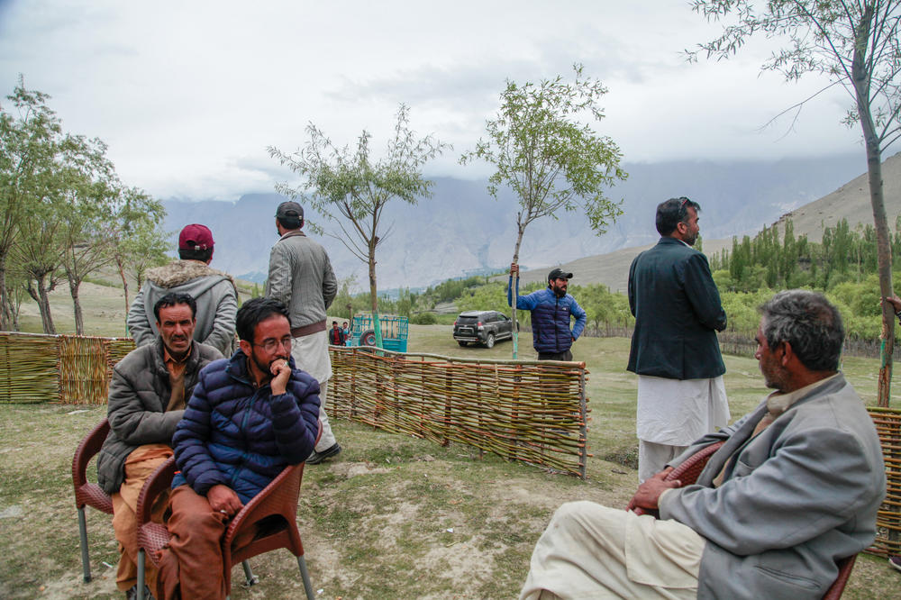 Men at a tea house perched over their village of Chunda. They're part of a group that's trying to mate glaciers to create a new glacier baby as human-induced warming rapidly melts the glaciers the residents have traditionally relied on for water. The U.N. is supporting their efforts.