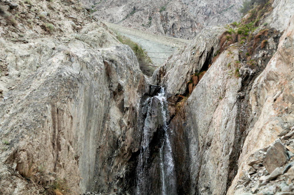 A gorge near the village of Skardu where academic Zakir Hussain is piloting the use of steel nets to harvest avalanches, which he says are increasing in frequency due to climate change. Built in the foothills of a mountain, the nets can trap rocks so they don't tumble down and damage the village — and also catch and filter snow and ice, sending meltwater into the dry river bed downstream.