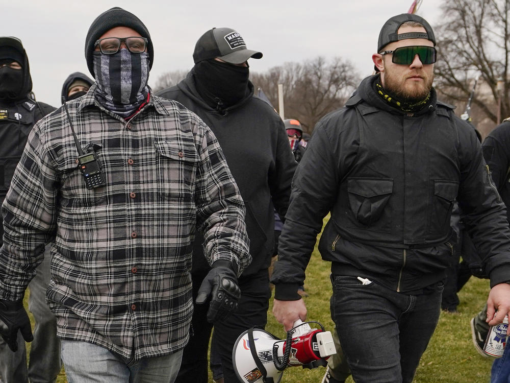 Proud Boys members Joseph Biggs, left, and Ethan Nordean, right with megaphone, walk toward the U.S. Capitol in Washington, Jan. 6, 2021.