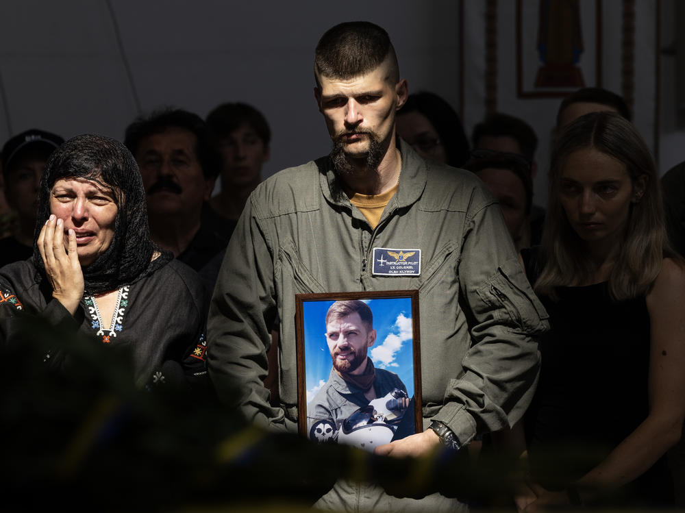 Relatives and soldiers mourn the death of fighter pilot Andrii 