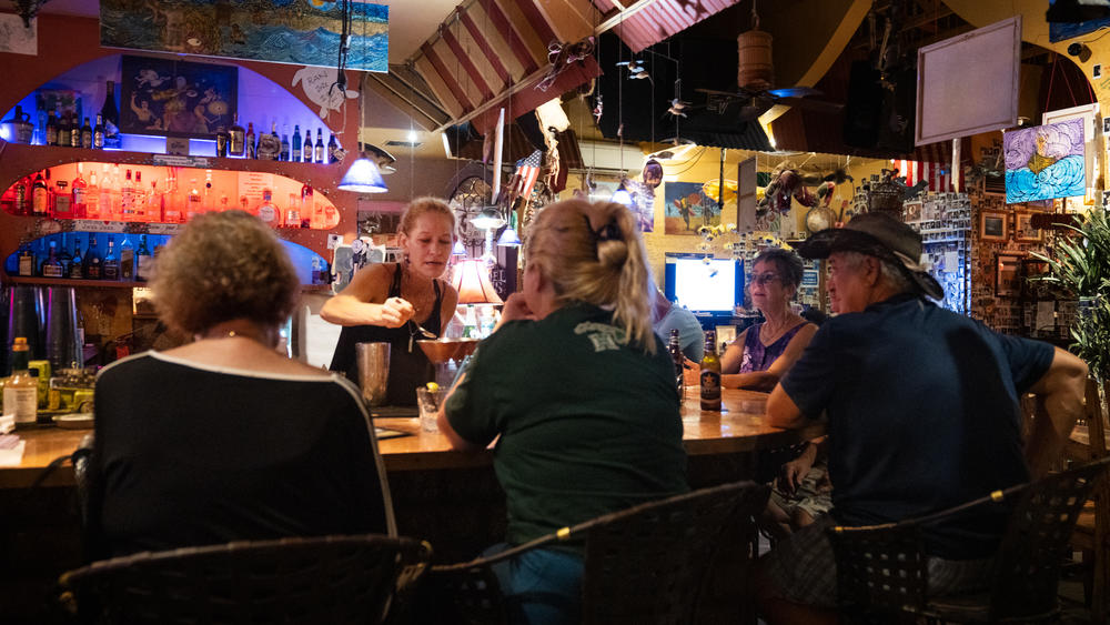 Cori Griffin, bartender at Java Jazz, greets residents with burst of joy to see that they've survived the fires.