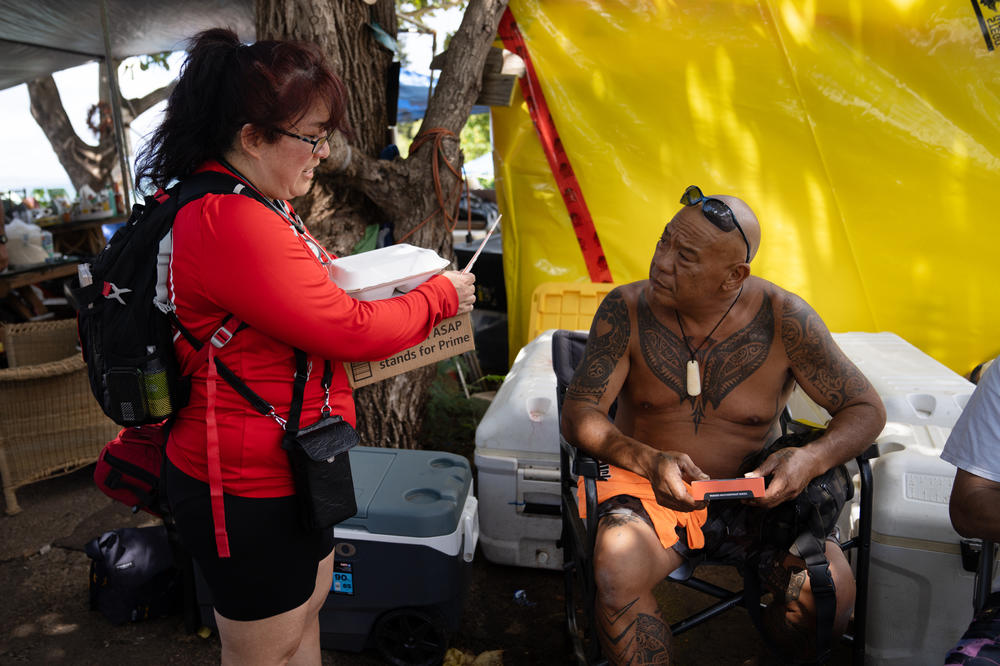 Joseph Ah Puk, a third generation Lahainan, talks with Dr. Niheu at the boat ramp. Ah Puk has two nieces and a brother that lost their homes in the fire. It missed his house by two blocks.