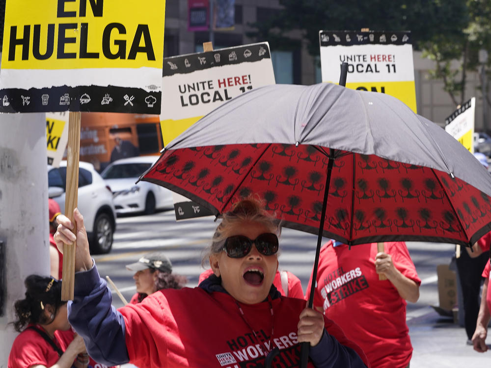 Striking hotel workers rally outside the InterContinental Los Angeles Downtown Hotel on Tuesday, July 4, 2023. (AP Photo/Damian Dovarganes)