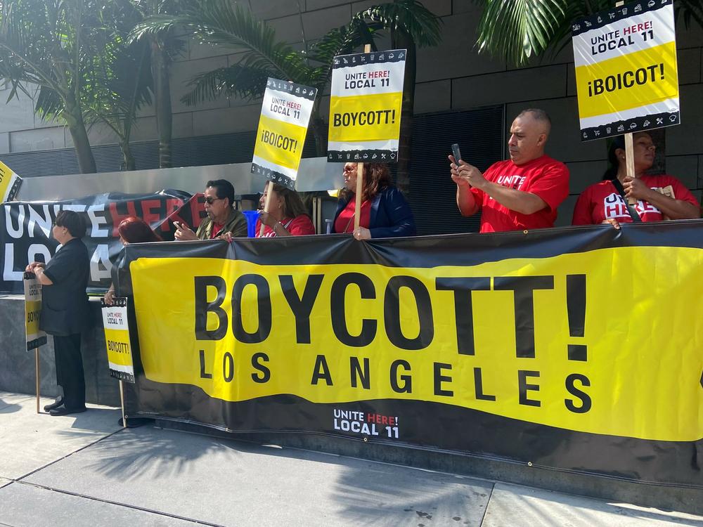 Members of Unite Here Local 11 picket in front of the JW Marriott hotel in downtown Los Angeles on August 24, 2023.