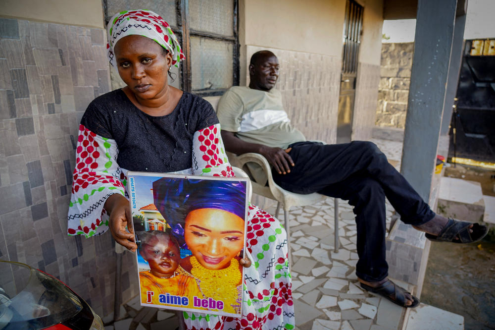 Mariama Kuyateh, 30, holds up a picture of her son Musa, whose death from acute kidney failure on Oct. 10 was linked to contaminated cough syrup imported to Gambia, where they live, from India. The World Health Organization issued an alert about the medication.
