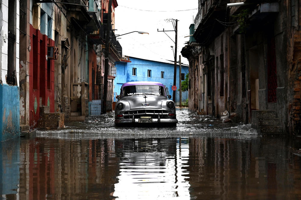 An old car drives through a flooded street in Havana, on Augusto 29, 2023, during the passage of tropical storm Idalia.