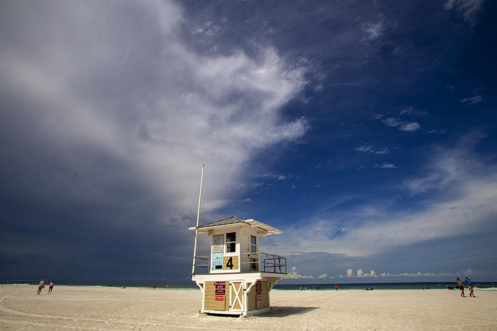 A lifeguard tower sits empty on Clearwater Beach while dark clouds loom overhead, before Hurricane Idalia hit in Clearwater, Florida.