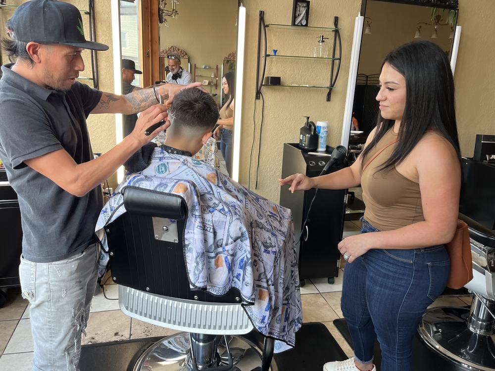 Jennifer Nuno checks her 11-year-old son's back-to-school haircut in the Lincoln Village neighborhood of Milwaukee on August 21.