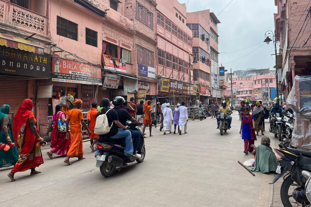 In Varanasi, Muslim men in skull caps and Hindu pilgrims wearing saffron clothes make their way to a temple-mosque complex that's the subject of an ongoing dispute.
