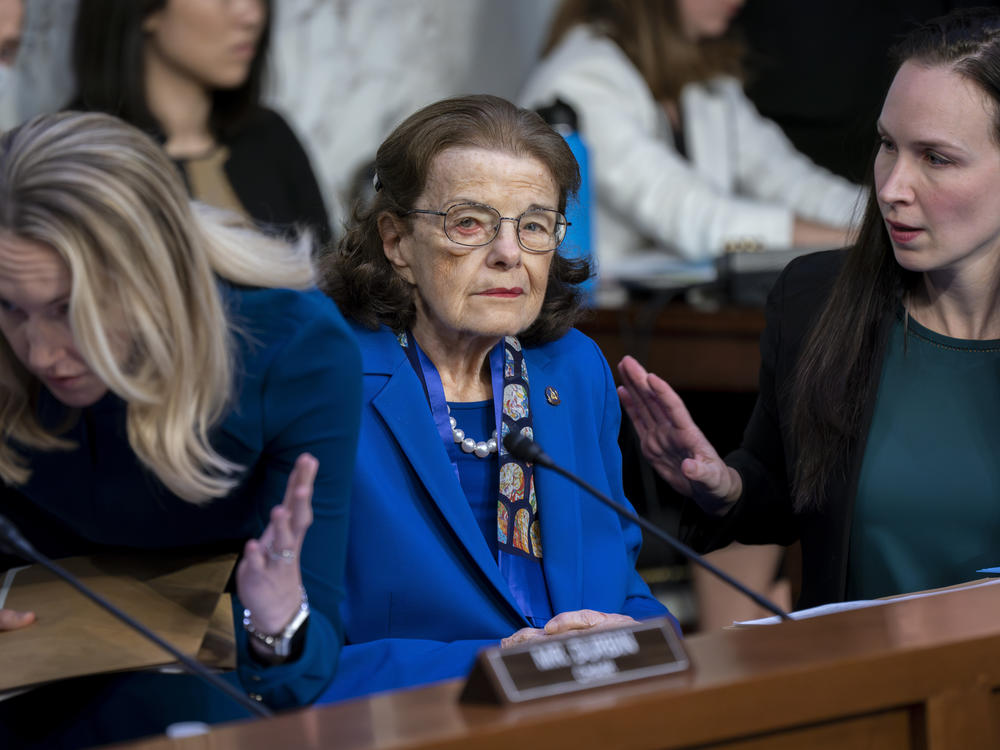 Sen. Dianne Feinstein, D-Calif., is flanked by aides as she returns to the Senate Judiciary Committee on May 11.