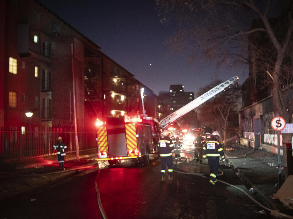 Firefighters work on the scene of a deadly blaze in downtown Johannesburg Thursday, Aug. 31, 2023.