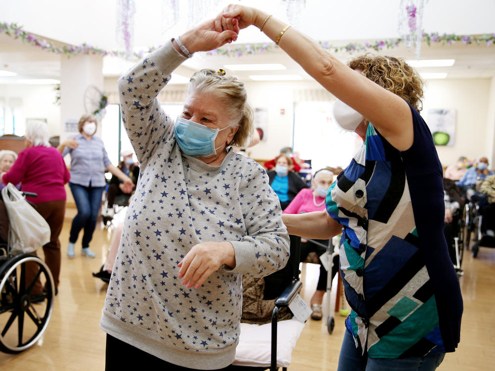 Residents and staff gather for a dance at the Ararat Nursing Facility in Los Angeles in April 2021. The pandemic exposed the dangers of inadequate staffing at nursing homes.