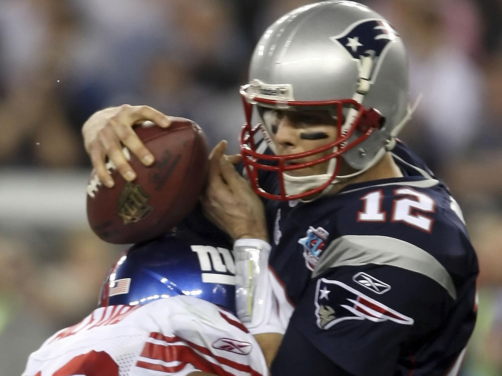 Defensive tackle Jay Alford of the New York Giants sacks quarterback Tom Brady, No. 12, of the New England Patriots for a 10-yard loss in the final minute of Super Bowl XLII on Feb. 3, 2008, at the University of Phoenix Stadium in Glendale, Ariz.