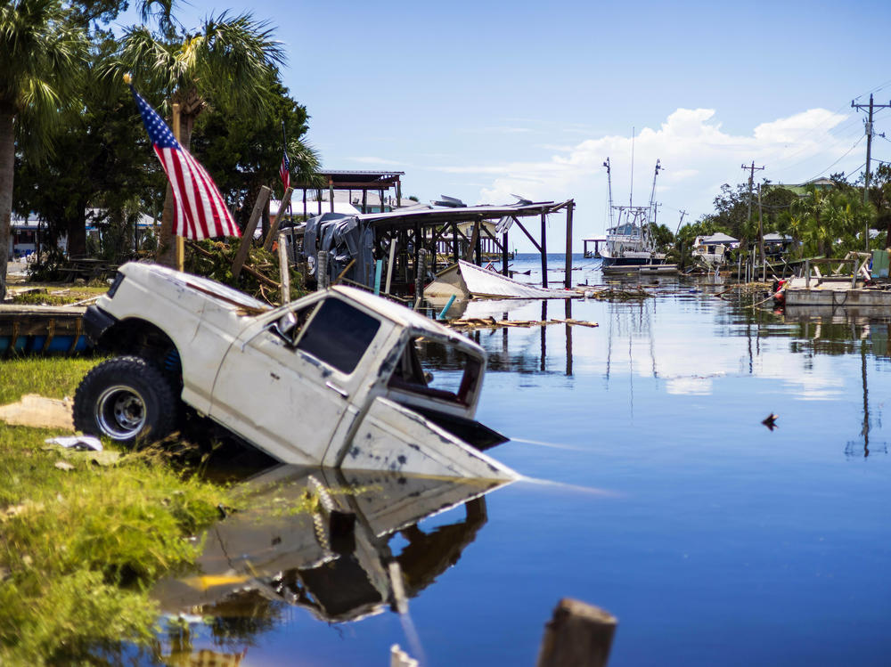 A pick up truck sinks into a canal.