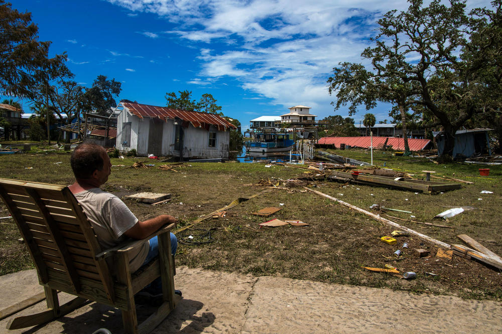 Austin Ellison sits and stares at his damaged property after Hurricane Idalia.
