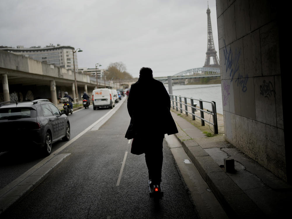 A man rides a scooter in Paris, on March 31. The city has now banned rental electric scooters.