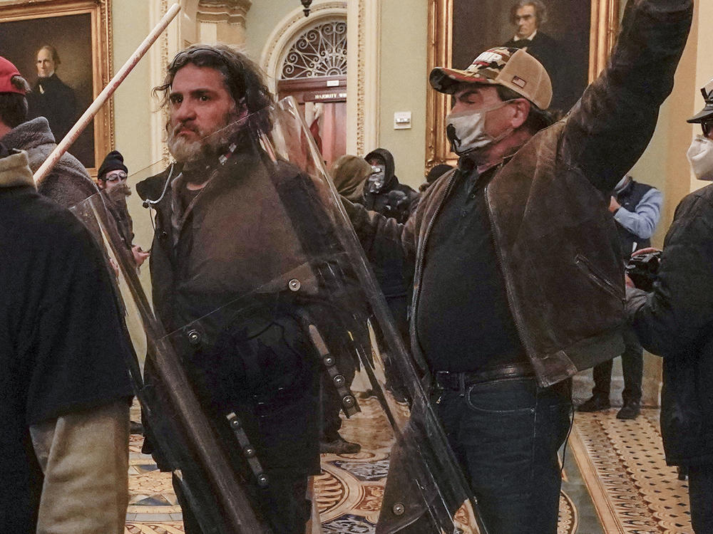 Rioters, including Dominic Pezzola, center with police shield, are confronted by U.S. Capitol Police officers outside the Senate Chamber inside the Capitol on Jan. 6, 2021, in Washington, D.C.