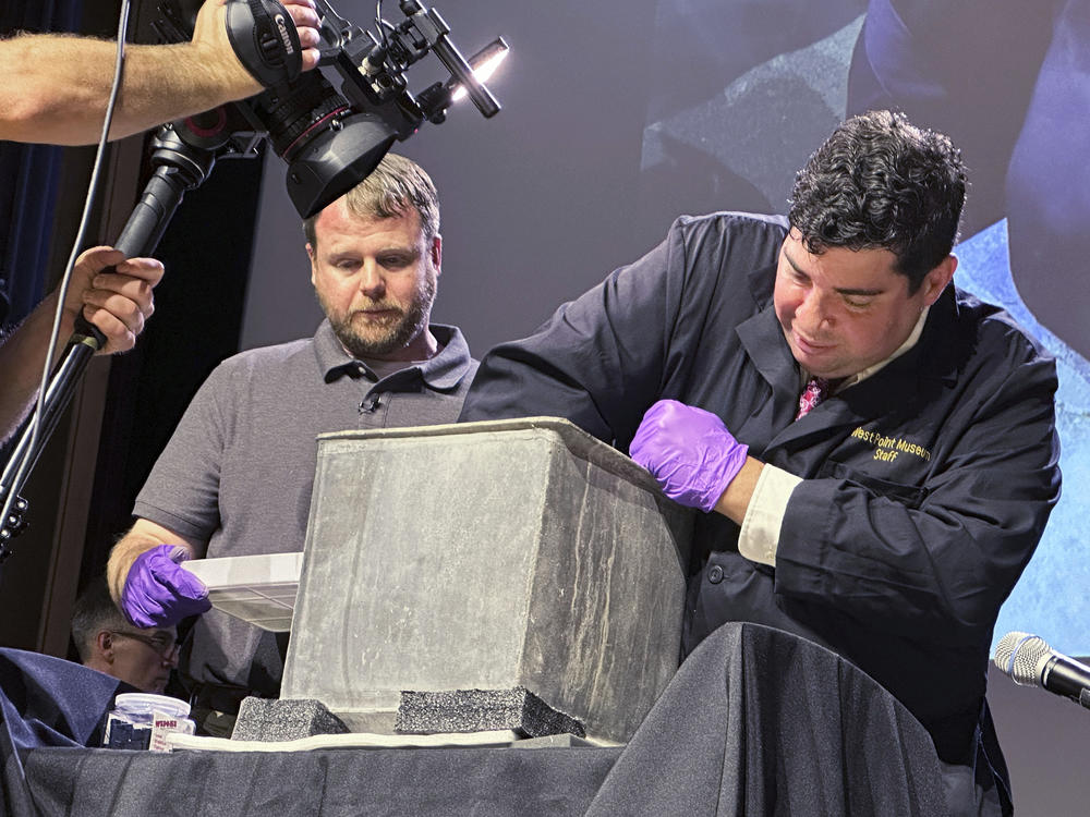 A West Point archeologist and  museum curator take part in the opening of a lead box placed in the base of a monument by cadets almost two centuries ago.