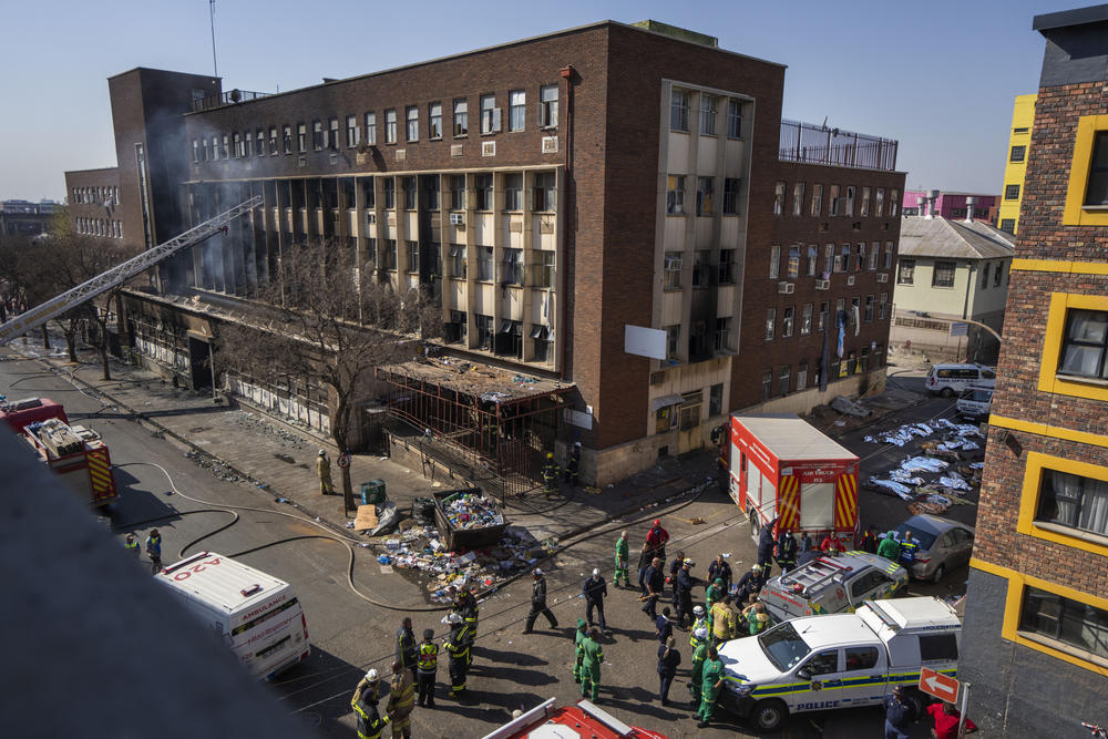 Medics and emergency works at the scene of a deadly blaze in downtown Johannesburg Thursday.