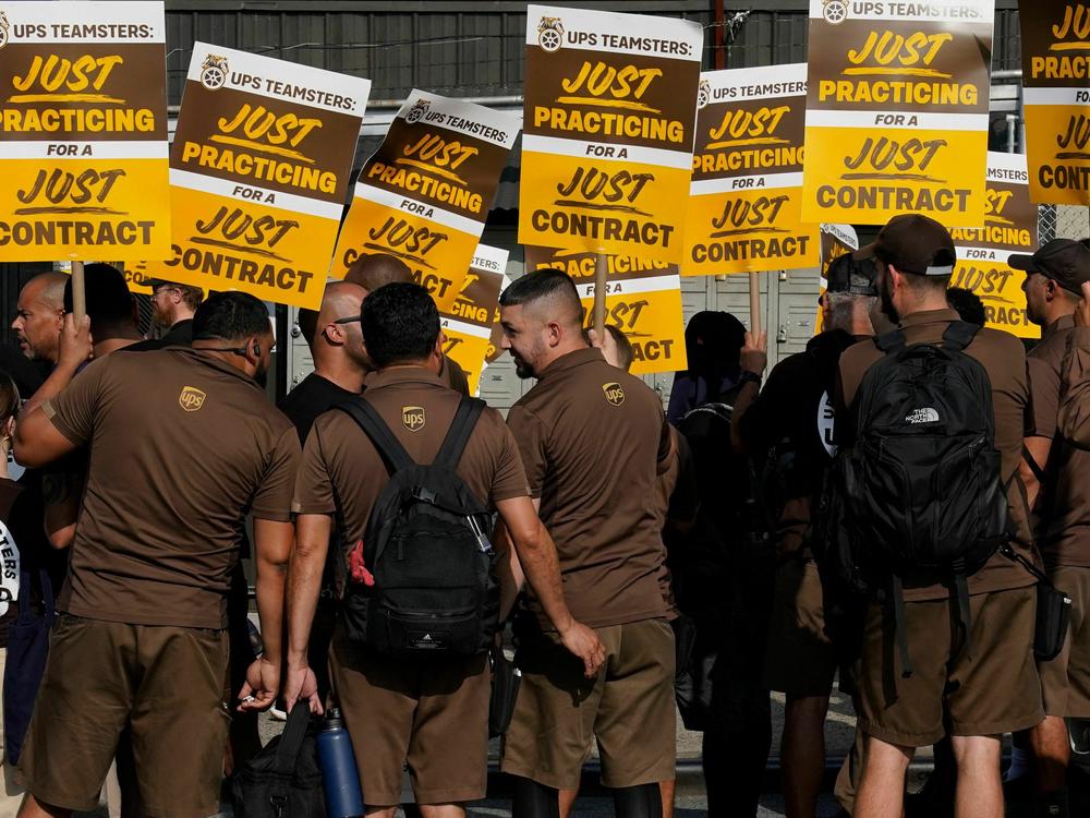 UPS workers walk a 