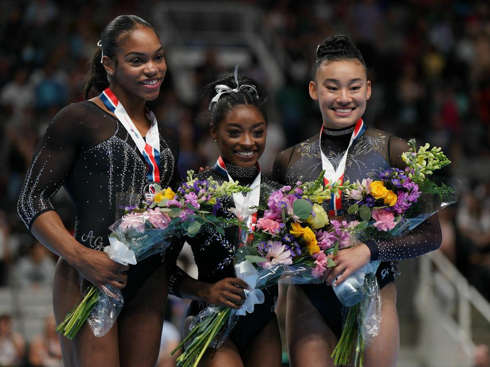Gymnasts Shilese Jones, Simone Biles and Leanne Wong pose after placing second, first and third in the all-around competition on the final day of women's competition at the 2023 U.S. Gymnastics Championships on Sunday in San Jose, Calif.